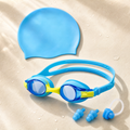 Blue kids swim goggles set with blue silicone swim cap, nose clip and earplugs